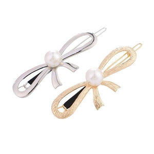Set of two bow-shaped alloy hair clips with brushed metal finish and center pearl accents