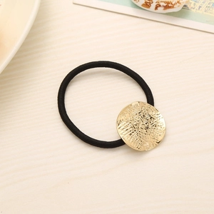 Black high-elastic hair tie featuring a round golden textured metal accent piece