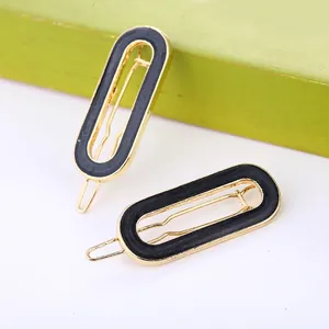 Minimalist gold metal hair clips with black matte inlay in a two-piece set