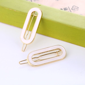Cute oval hair clips for women with white enamel finish on gold alloy frames