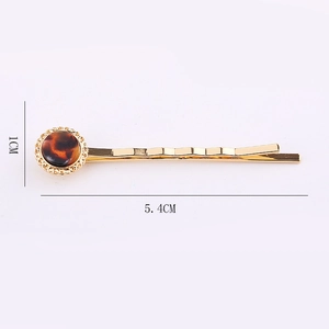 Golden wave hair clip with a 1cm round tortoiseshell resin inlay and beaded edge