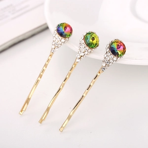 Lot de trois barrettes dorées en forme de fleurs avec cristaux et strass brillants