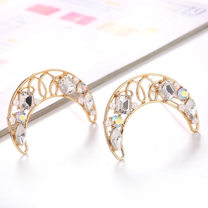 Detail of crescent moon earrings with gold alloy, crystals and small pearls decoration