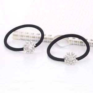 Close-up of black elastic hair ties featuring intricate silver snowflake zircon charms