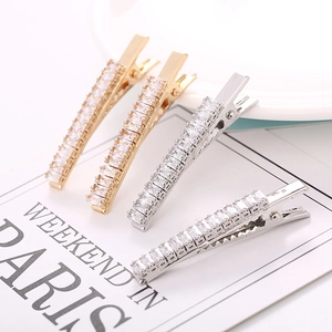 Set of four shiny zircon duckbill hair clips with gold and silver metal bases