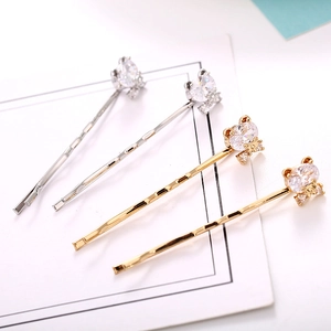Set of four gold and silver wave hair clips with sparkling zircon ear-shaped stones