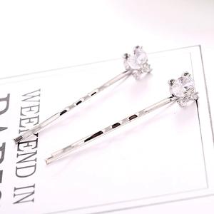 Detail of silver alloy hair clips set featuring heart and round cubic zirconia stones
