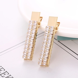 Detail of gold alligator hair clips with double-row sparkling white zircon crystals