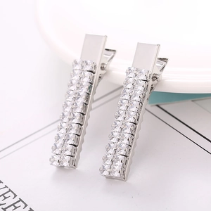 Macro view of silver rectangle duckbill hair clips with sparkling clear rhinestones