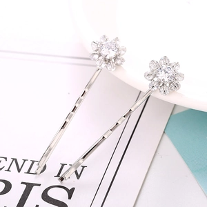Close-up of elegant silver flower hair clips with clear zircon stone settings