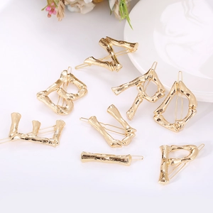 Golden bamboo texture alphabet hair pins set with minimalist metal letter designs
