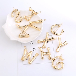 Golden bamboo texture letter hair clip collection featuring various alphabet shapes for women