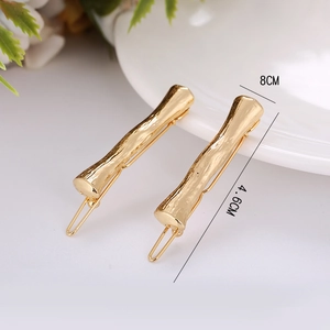 Detailed close-up of golden bamboo textured hair clips with 4.6cm length measurement
