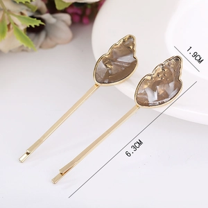 Detail view of acetate ice cream hair pins with 6.3cm gold alloy and amber resin charms