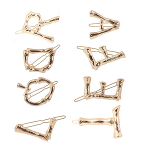 Golden bamboo-textured alphabet hair clip set with minimalist vintage metal design