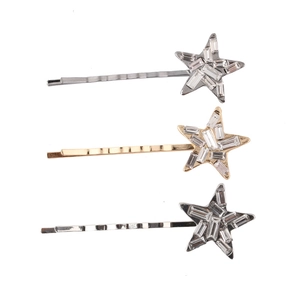 Trois barrettes étoiles en or, argent et noir ornées de cristaux scintillants