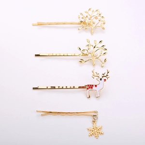 4-piece set of gold Christmas hair clips with reindeer, snowflake, and tree charms