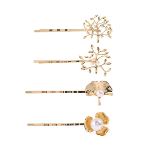 Lot de quatre barrettes dorées aux motifs de feuilles, fleurs et branches avec perles