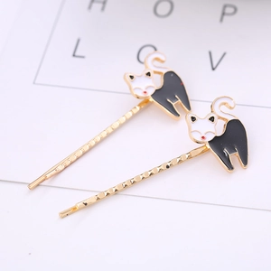 Detail view of cute cartoon cat hair clips with golden wavy pins and black oil-dripping finish