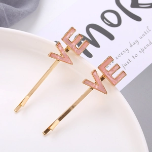 Pink marble texture LOVE alphabet hair clips set in gold tone on white ceramic tray