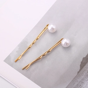 Minimalist gold pearl bobby pins set featuring round faux pearls on polished alloy metal