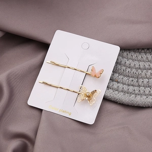 Elegant gold-plated butterfly hair clips set with peach pink butterfly and rhinestone details