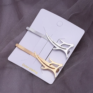 Modern geometric alloy hair clips in gold and silver set on a white display card