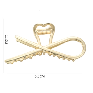 Vue détaillée d'une grande pince à cheveux en métal doré avec dimensions 11cm x 5,5cm