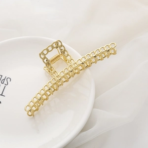 Large matte gold metal hair claw clip with hollow chain design for elegant hairstyles