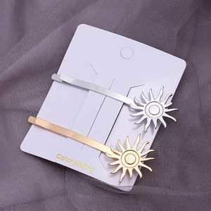 Golden and silver sun-shaped alloy hair clips with stylish color plating on cards