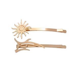 Gold-plated alloy hair clip set featuring sunburst and streamlined minimalist designs