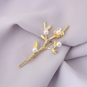 Elegant gold flower hair clip with white pearls in vintage Chinese style aesthetic