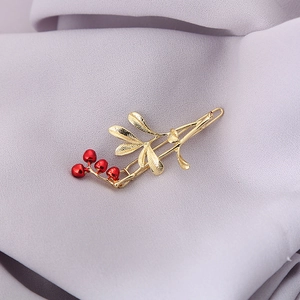 Elegant Chinese style golden hair clip with maple leaf design and bright red berry accents