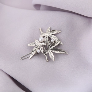 Elegant maple leaf hair clip with pearls in antique silver on purple fabric