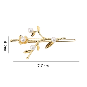 Detailed view of golden branch hair clip with pearls measuring 7.2cm by 4.2cm
