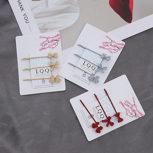 Ensemble de trois barrettes à nœuds en métal mat, coloris beige, bleu et rouge
