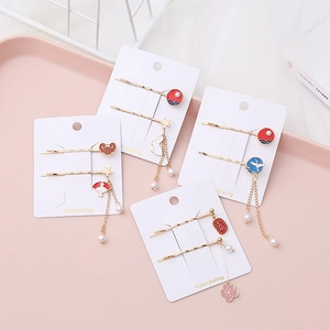 Traditional Chinese style hair clips with floral patterns, tassels and pearls on display