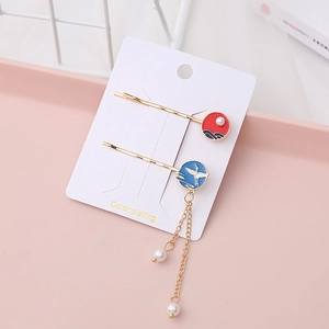 Detail of vintage style hair pins with crane pattern and elegant pearl tassels
