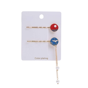 Detailed close-up of a two-piece Chinese tassel hair clip set with crane and wave motifs