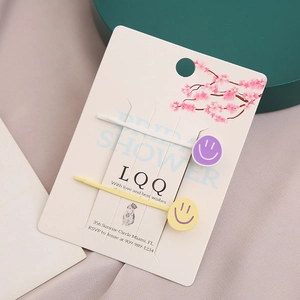 Lot de deux jolies barrettes à cheveux smiley sur une carte décorative fleurie