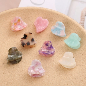 Set of 9 heart-shaped acetate hair claw clips with leopard and marble patterns