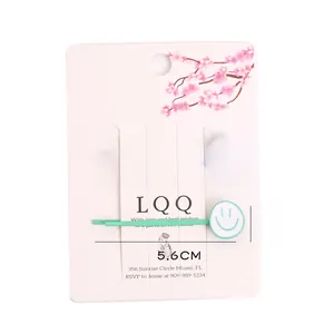 Détail de barrettes à cheveux avec visage souriant sur carte, longueur de 5,6 cm