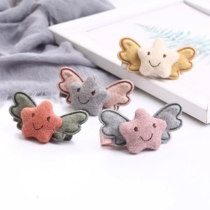 Set of four embroidered star hair clips with wings for kids in various soft colors