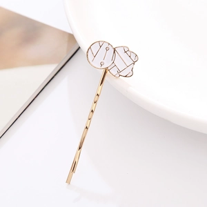 Minimalist gold Halloween hair clip with white geometric abstract charm for parties
