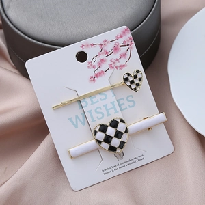 Checkboard heart hair clips set with gold plating on elegant decorative display