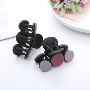 Close-up of matte French hair claws set with round accents and durable metal springs