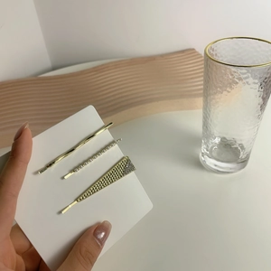 Three-piece gold metal hair clip set with pearls and geometric triangle designs