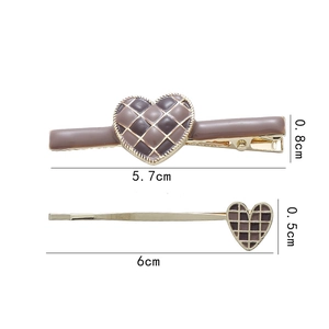 Detailed view of checkered heart hair clips with dimensions showing 5.7cm and 6cm length