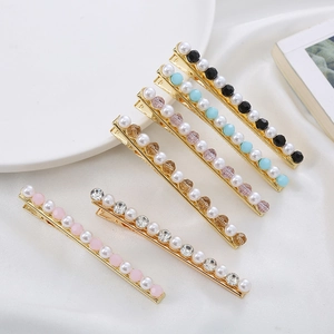 Elegant Korean style hair clips with pearls and crystals set on a silk fabric background