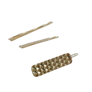 Three-piece golden hair clip set with white pearls and textured geometric wave patterns